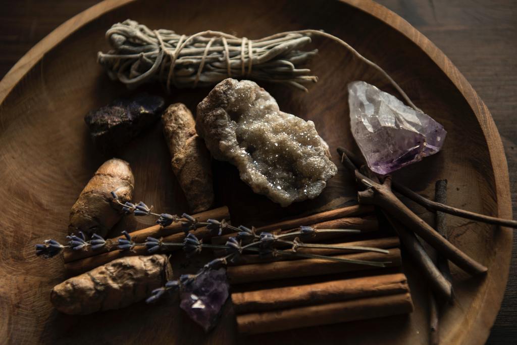 witch bowl full of crystals, sage, cinnamon, and lavender