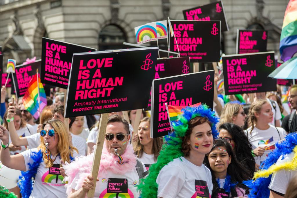 Gay pride march, signs read "Love is a human right"
