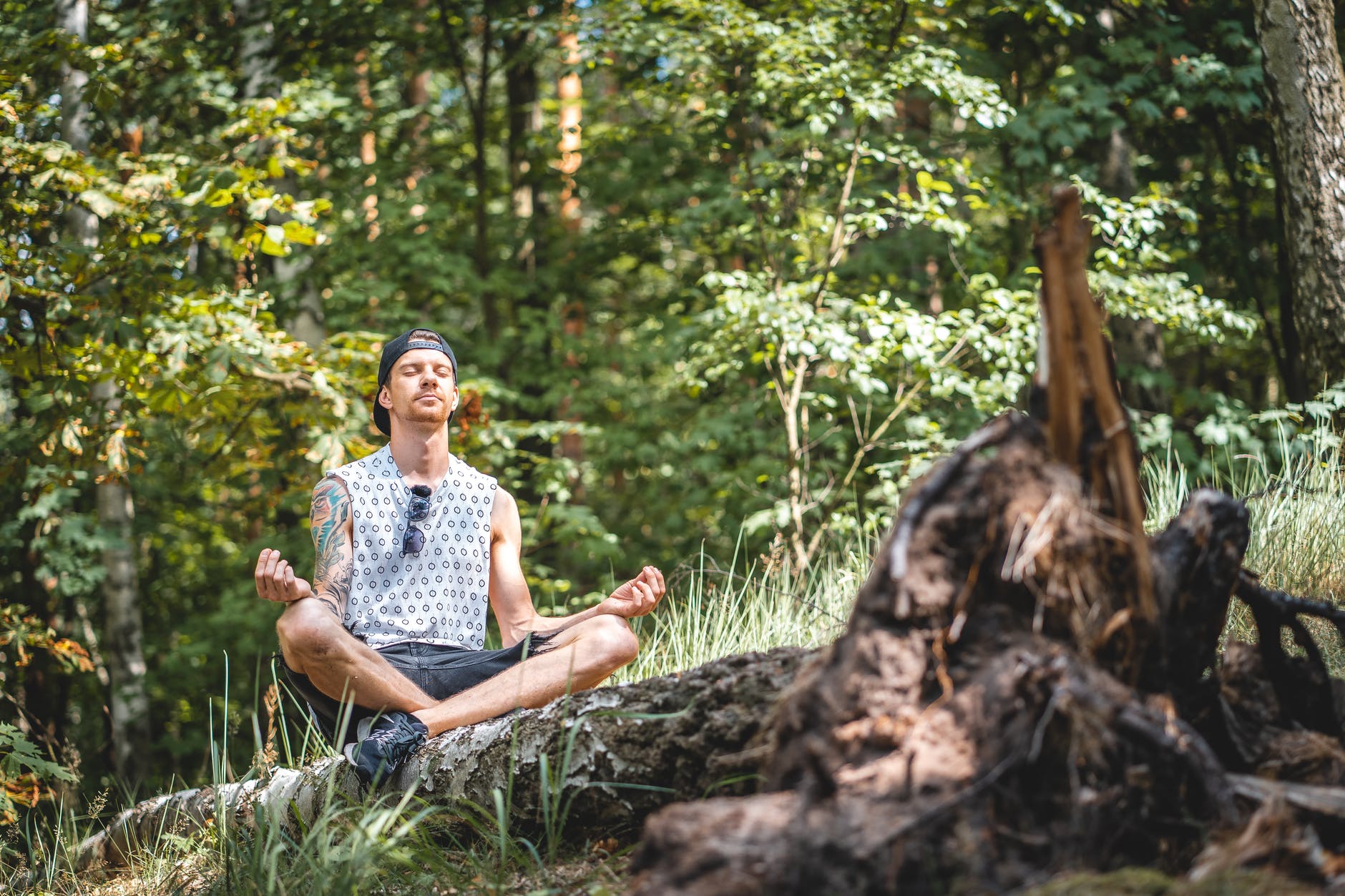 man meditating in the woods